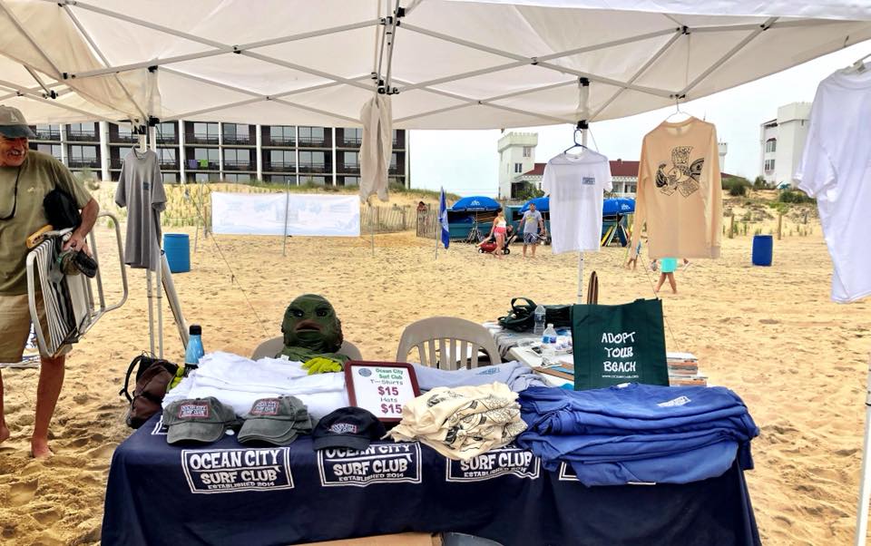 tent with t shirts on table with beach