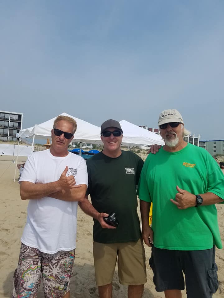 three older guys on the beach